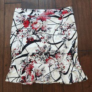White skirt with red, gray black flowers